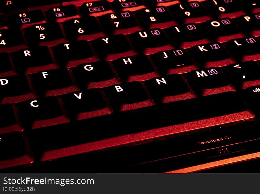 laptop keyboard with red colour tint