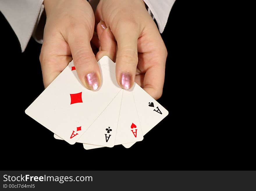 Four aces in female hands isolated on black. Four aces in female hands isolated on black