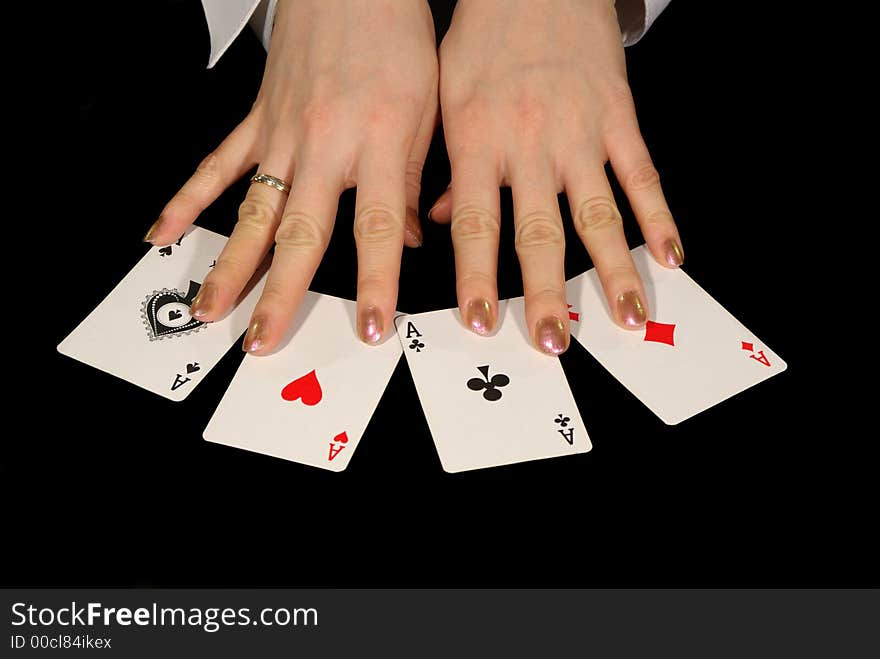 Four aces and female hands isolated on black. Four aces and female hands isolated on black