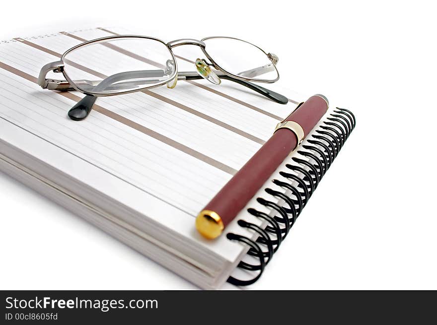 Notebook, glasses and pen on white background