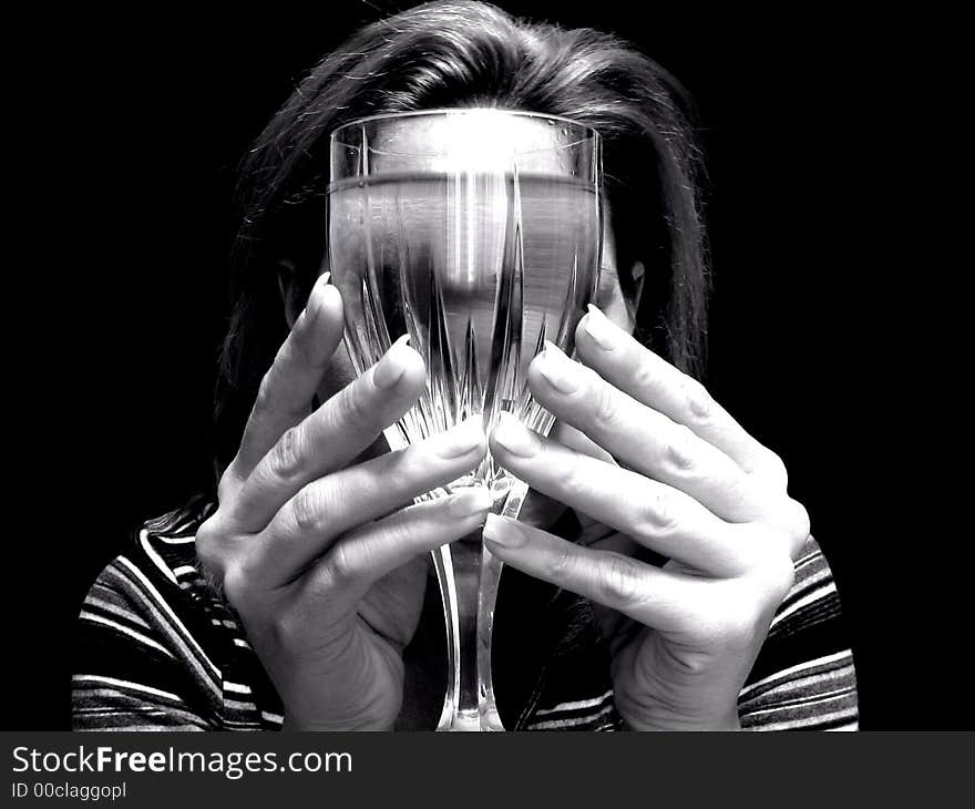 Black and white still of woman holding wine. Black and white still of woman holding wine