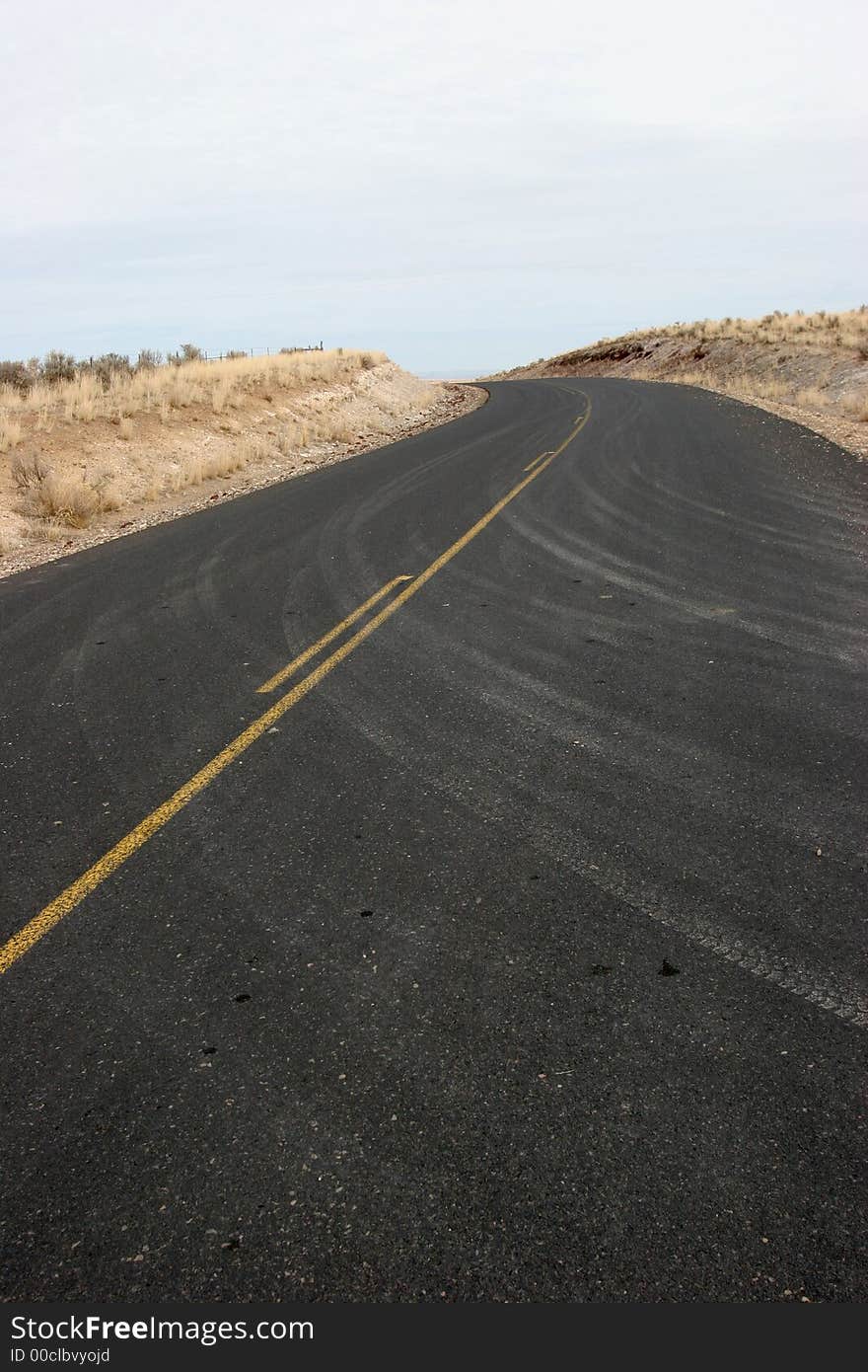 Curve in paved highway with dusty car tracks; clean, crisp, sharp image. Curve in paved highway with dusty car tracks; clean, crisp, sharp image.