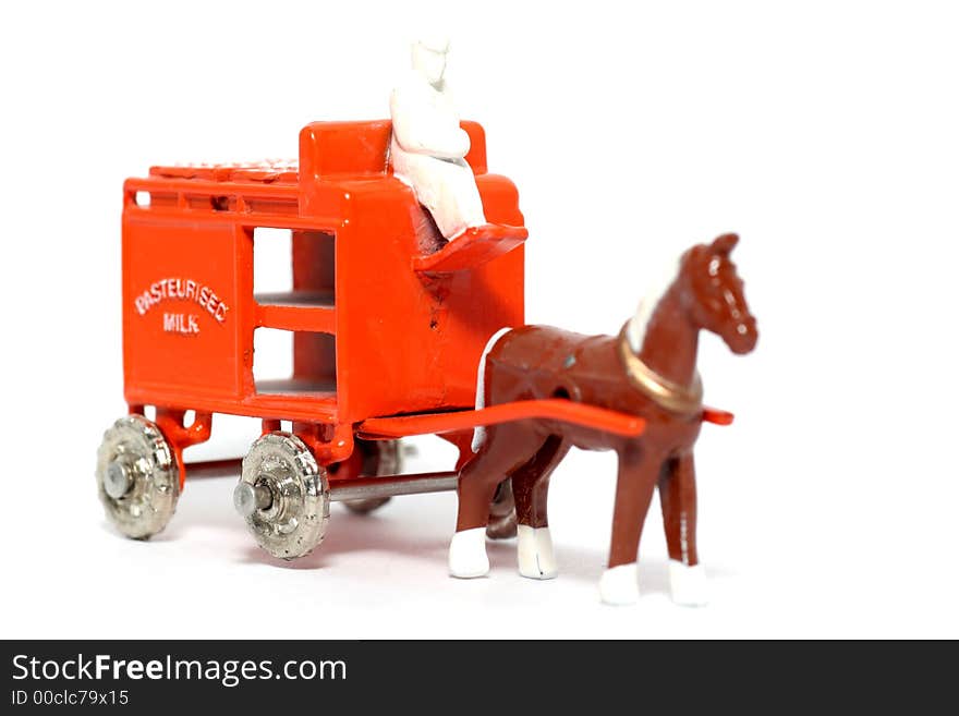 Picture of a old small toy Horse Drawn Milk Float. British metal toy from my brothers toy collection. Replica from a 1950's toy made in 1988.(so too not that young). Picture of a old small toy Horse Drawn Milk Float. British metal toy from my brothers toy collection. Replica from a 1950's toy made in 1988.(so too not that young)