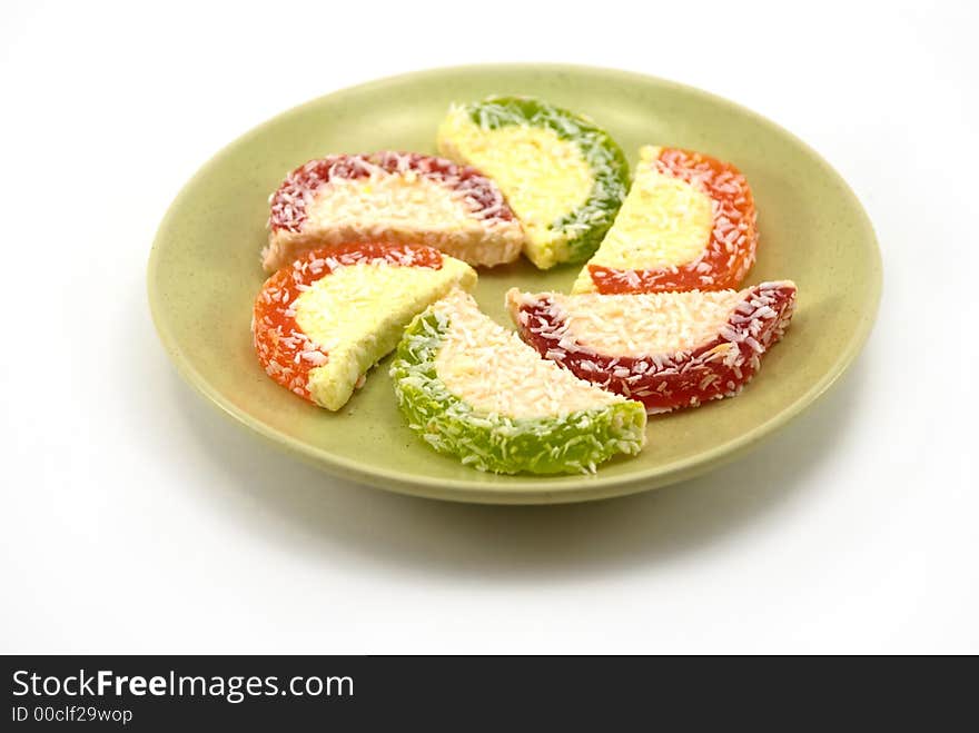 Beautiful fruit candy on a plate on a white background