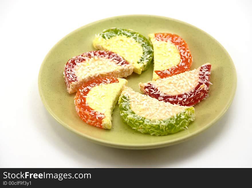 Beautiful fruit candy on a plate on a white background