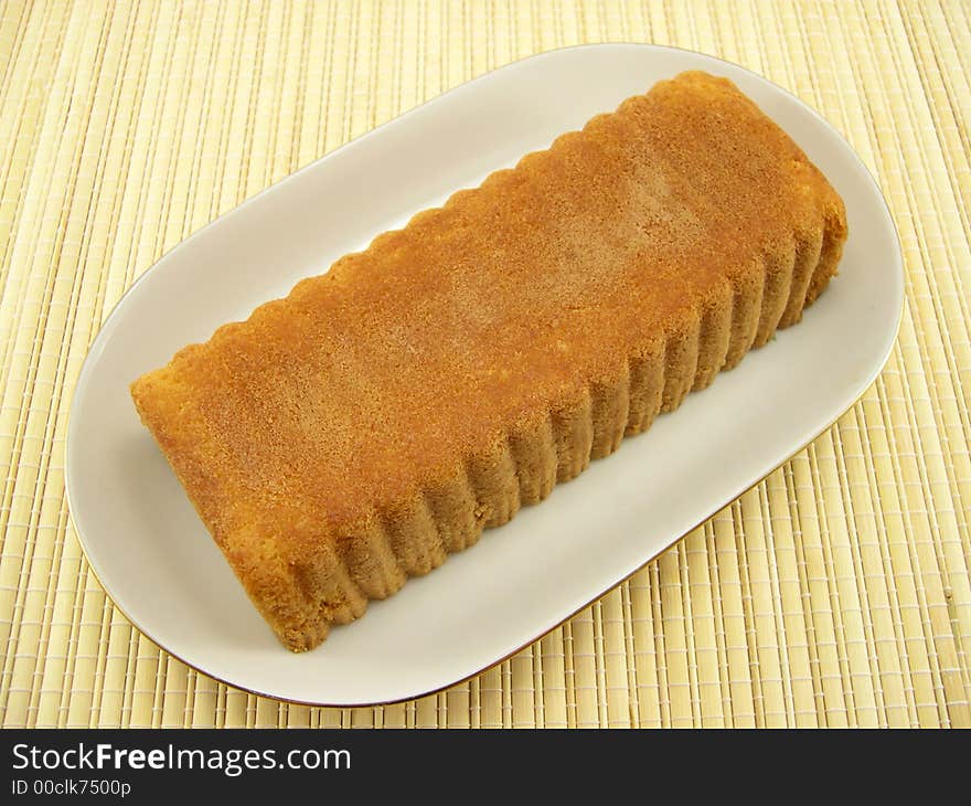 Beautiful fruitcake in a plate on a bamboo napkin