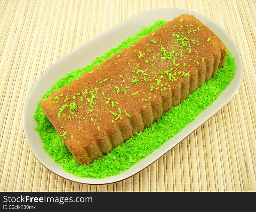 Beautiful fruitcake in a plate on a bamboo napkin