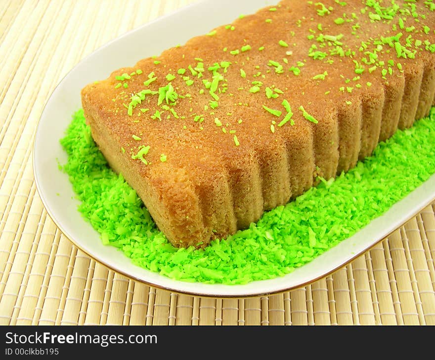 Beautiful fruitcake in a plate on a bamboo napkin