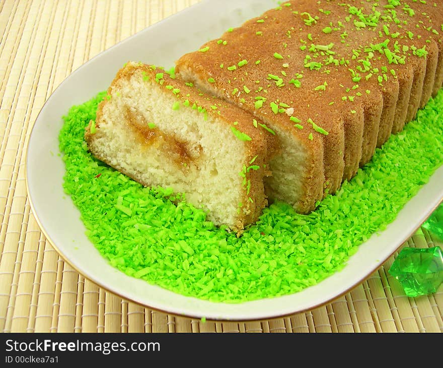 Beautiful fruitcake in a plate on a bamboo napkin