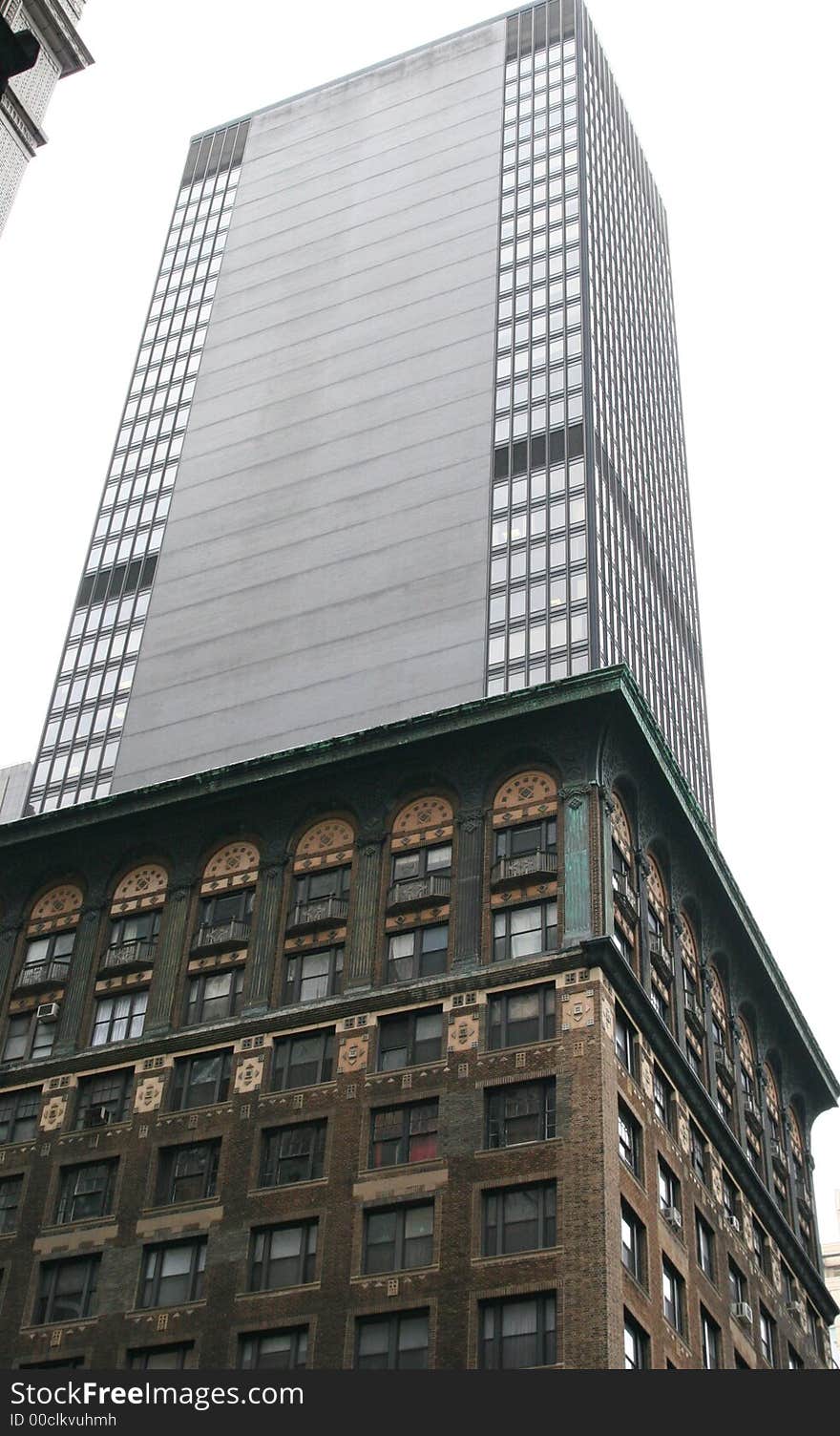 Old office building in front of modern glass skyscraper. Old office building in front of modern glass skyscraper