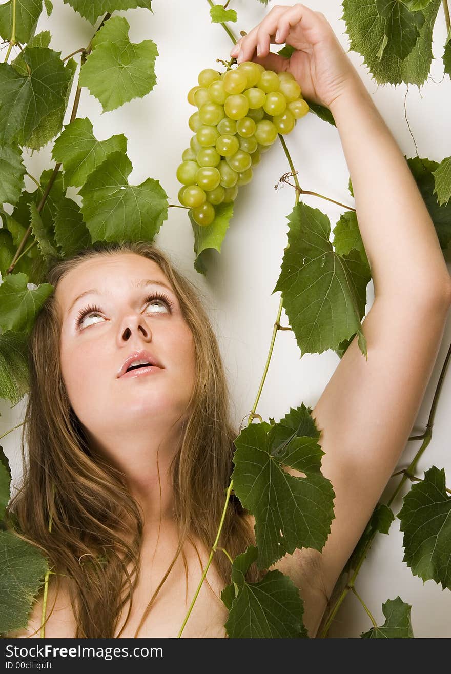 Beautiful young woman portrait with green grape. Beautiful young woman portrait with green grape