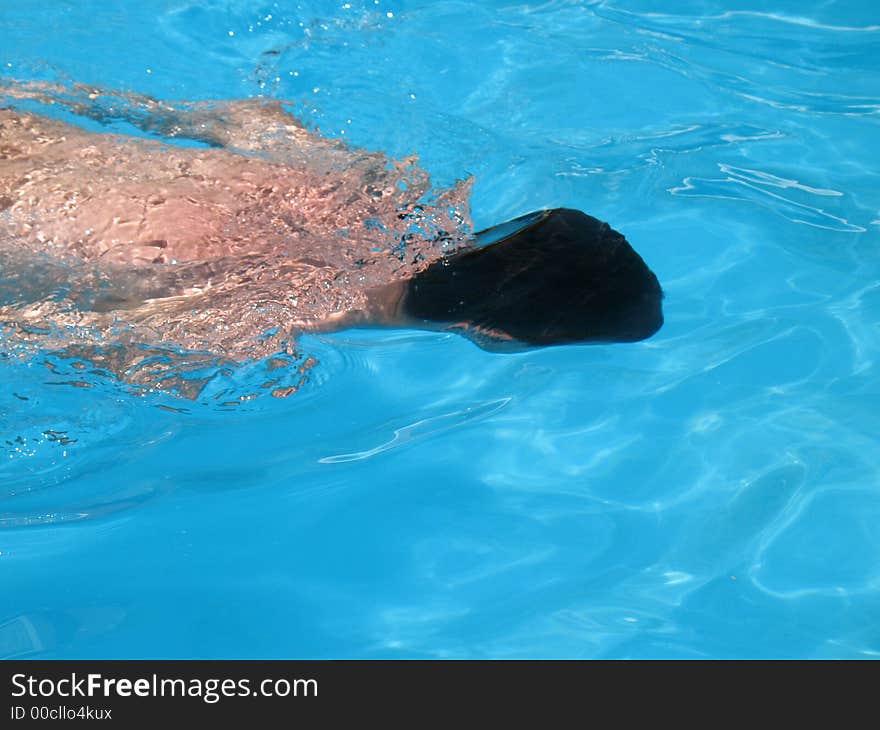 Man swimming in outdoors, blue water