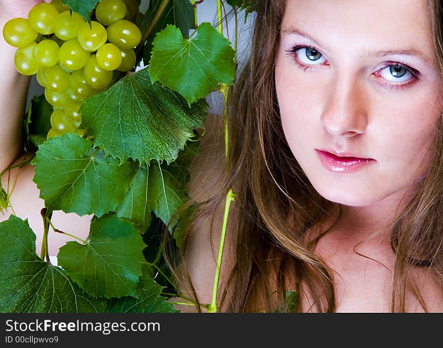 Beautiful young woman portrait with green grape. Beautiful young woman portrait with green grape