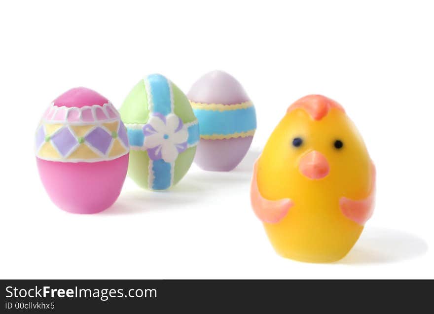 Pastel colored, wax Easter eggs on white background. Lots of DOF with focus on the chick egg leading his egg team. Unsharpened.