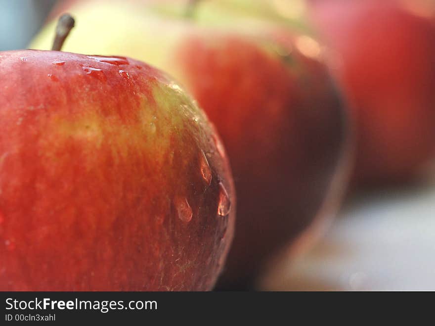 Row of red apples focusing. Row of red apples focusing