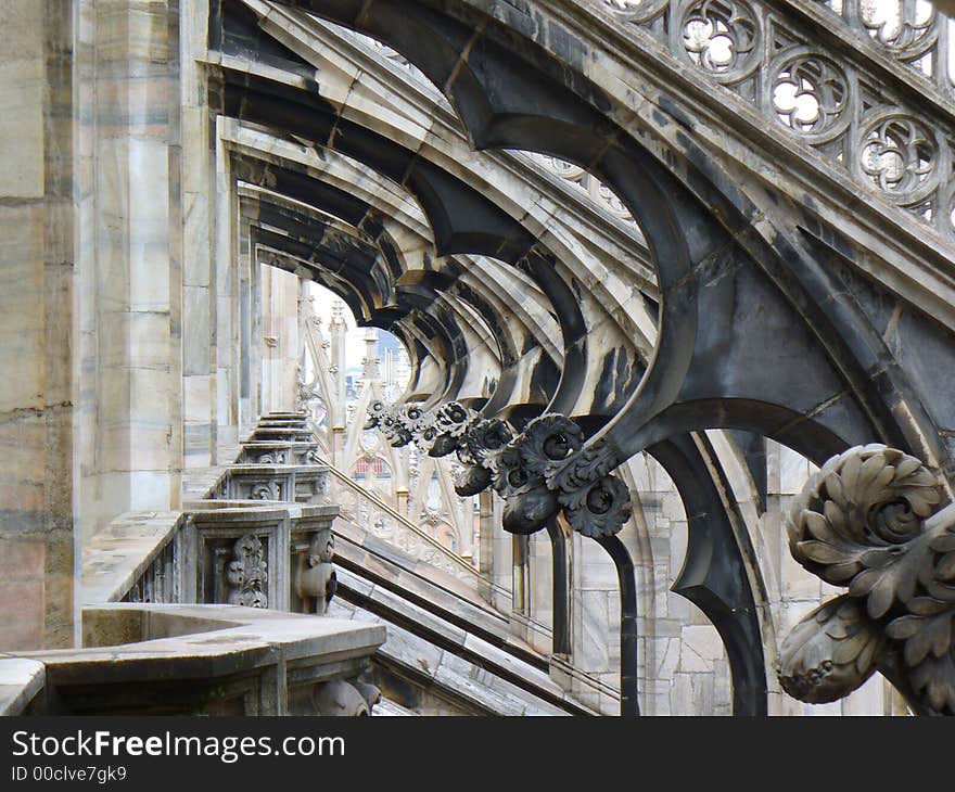 View through area in the decorative roof of Duomo cathedral in Milan. View through area in the decorative roof of Duomo cathedral in Milan