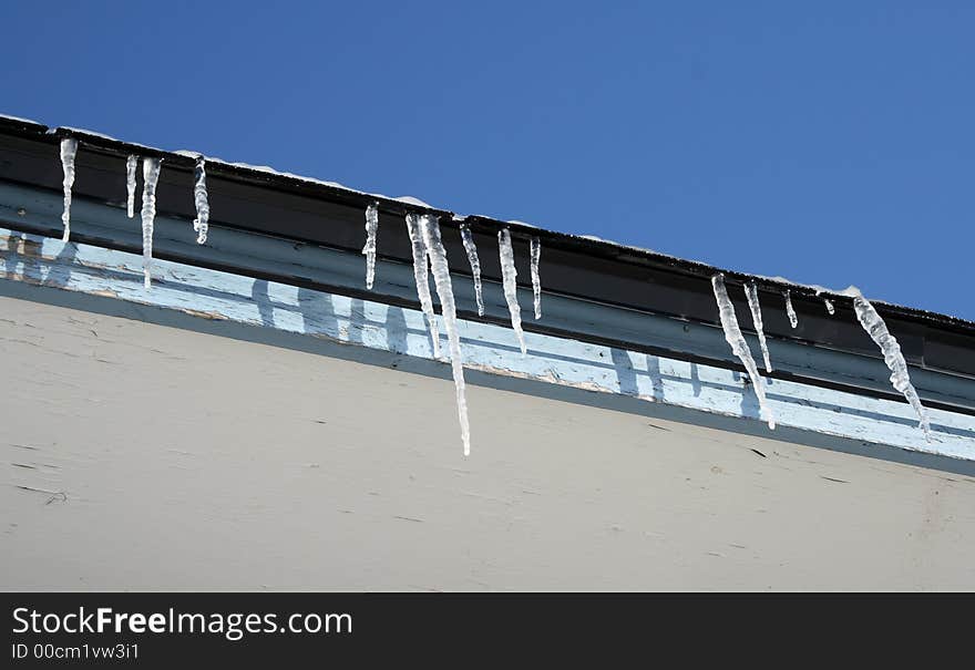 Bright winter day, icicles on the roof