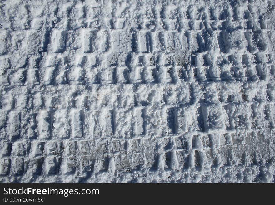 Car tracks imprinted in snow. Car tracks imprinted in snow.