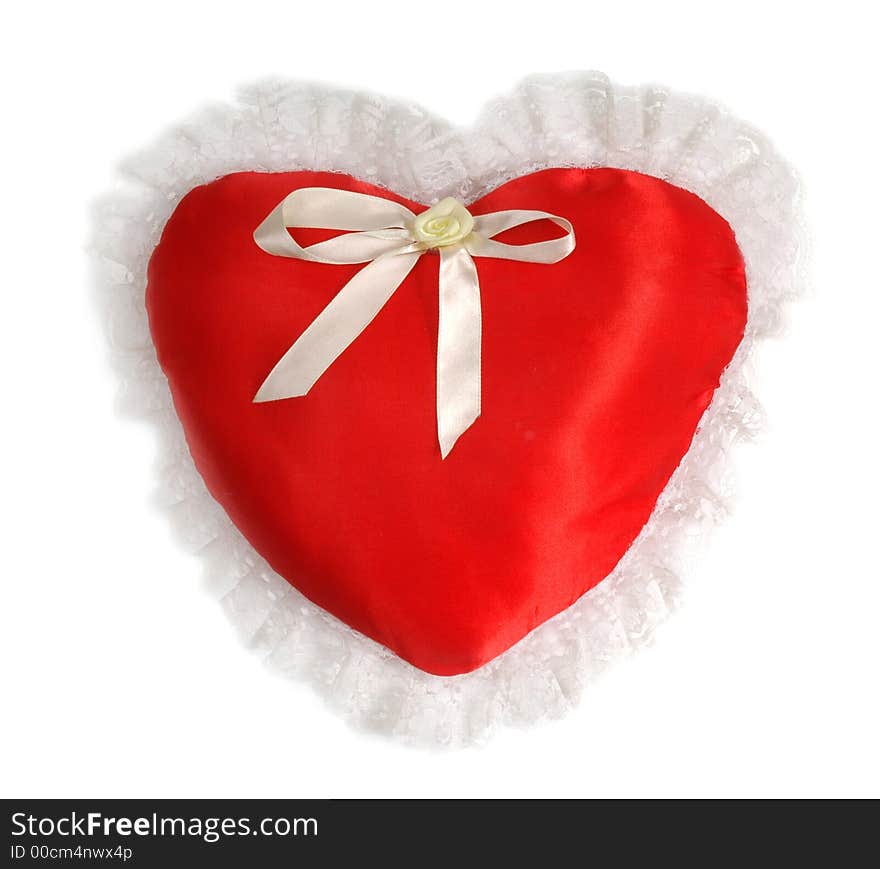 Red pillow as a heart on the day of sainted Valentine on a white