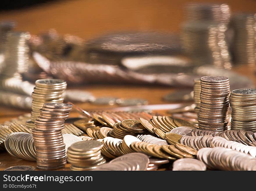 Set of coins on a table with a curve mirror, (studio, halogen light). Set of coins on a table with a curve mirror, (studio, halogen light).