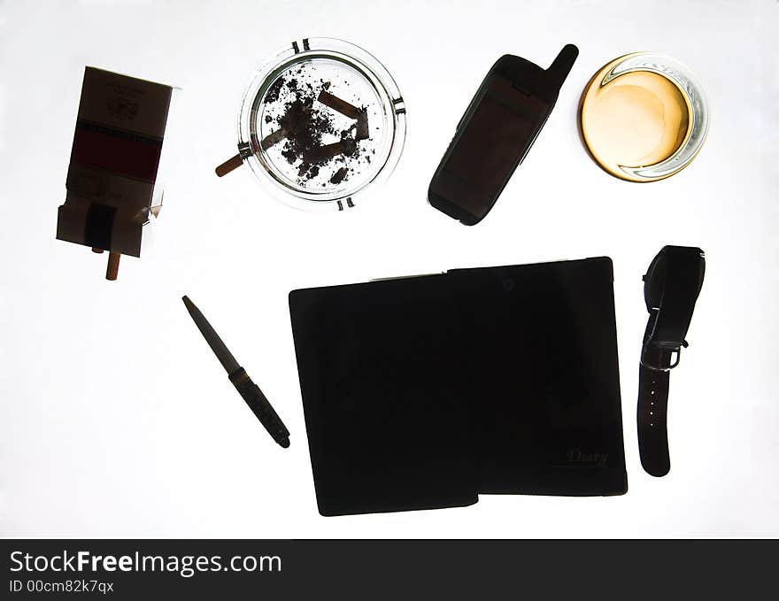 The pen, ashtray, cigarettes, telephone, etc. on glass, (studio, halogen light). The pen, ashtray, cigarettes, telephone, etc. on glass, (studio, halogen light).