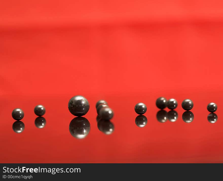 Steel rusty balls on the glass, (studio, halogen light, screen). Steel rusty balls on the glass, (studio, halogen light, screen).