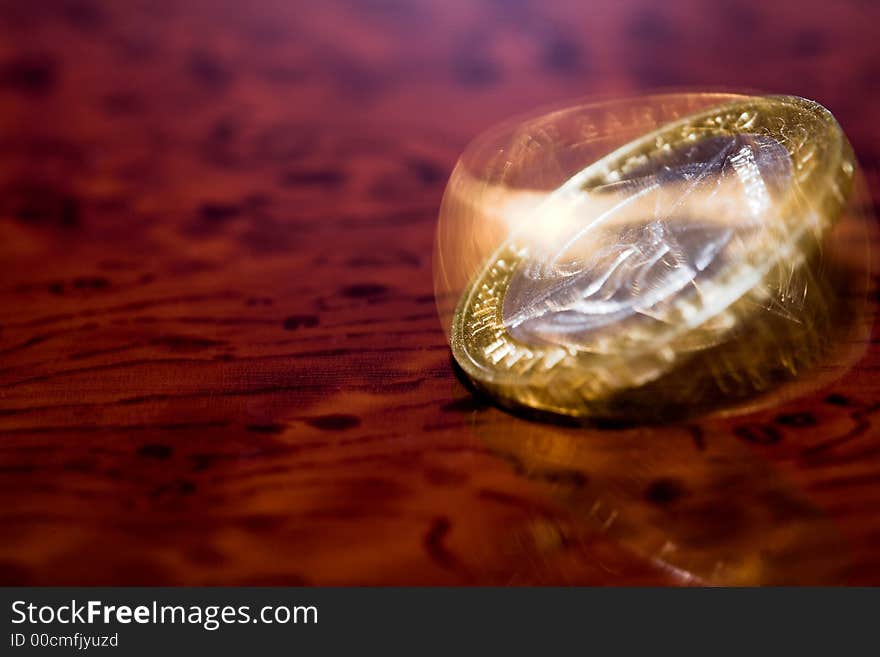 Turning coin on a table. Turning coin on a table