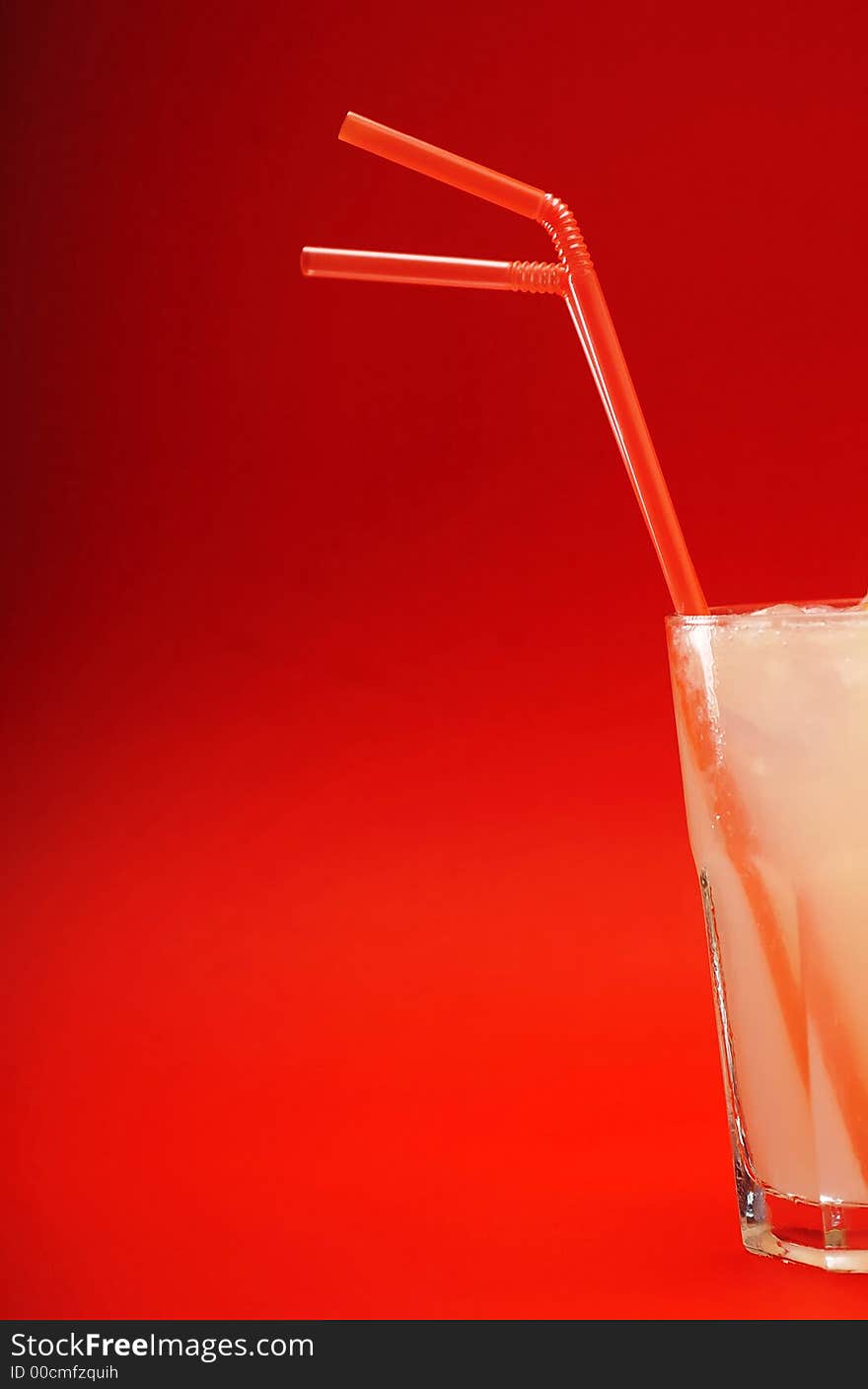 Glass of alcohol cocktail in a front of red background. Glass of alcohol cocktail in a front of red background