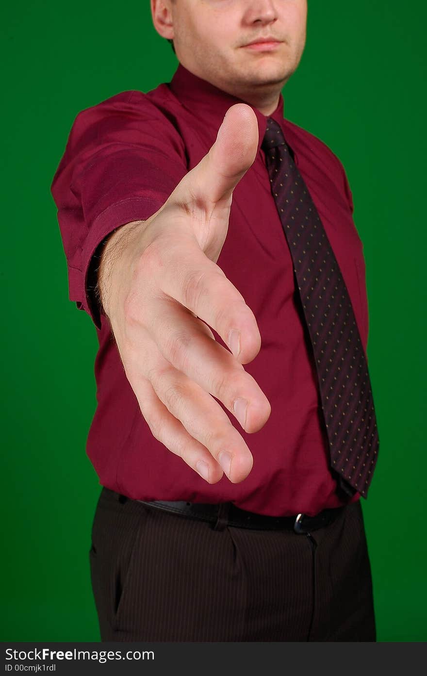 The stretched hand of the businessman in a tie