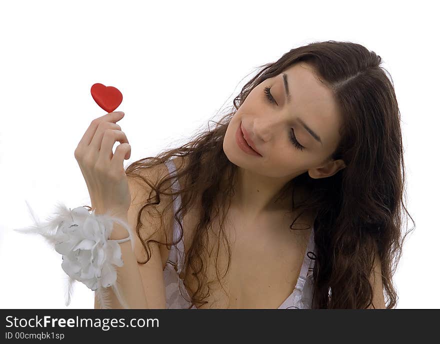 Beautiful young woman holding little heart in hand - isolated on white. Beautiful young woman holding little heart in hand - isolated on white