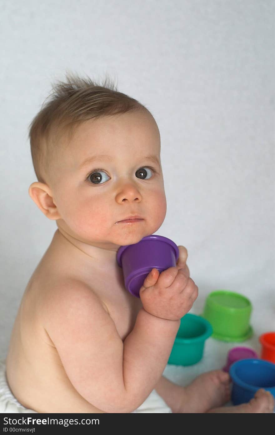 Image of adorable baby playing with stacking cups. Image of adorable baby playing with stacking cups