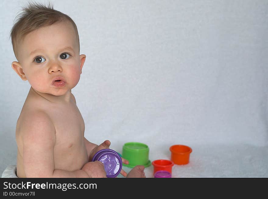 Image of adorable baby playing with stacking cups. Image of adorable baby playing with stacking cups