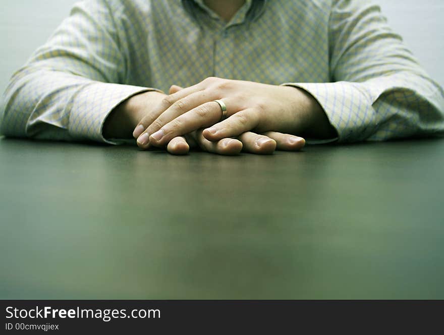 Male hands on a brown table waiting for a partner for discussion. Male hands on a brown table waiting for a partner for discussion