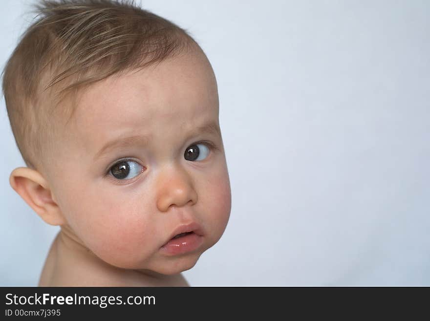 Portrait of beautiful 10 month old baby sitting in front of white background. Portrait of beautiful 10 month old baby sitting in front of white background