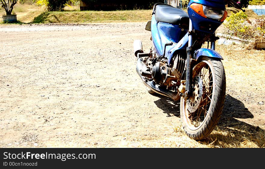 Blue Motocycle parking in sunny day. Blue Motocycle parking in sunny day.