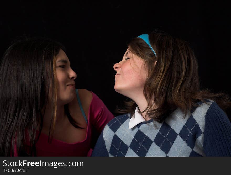 Teen posing over black backdrop