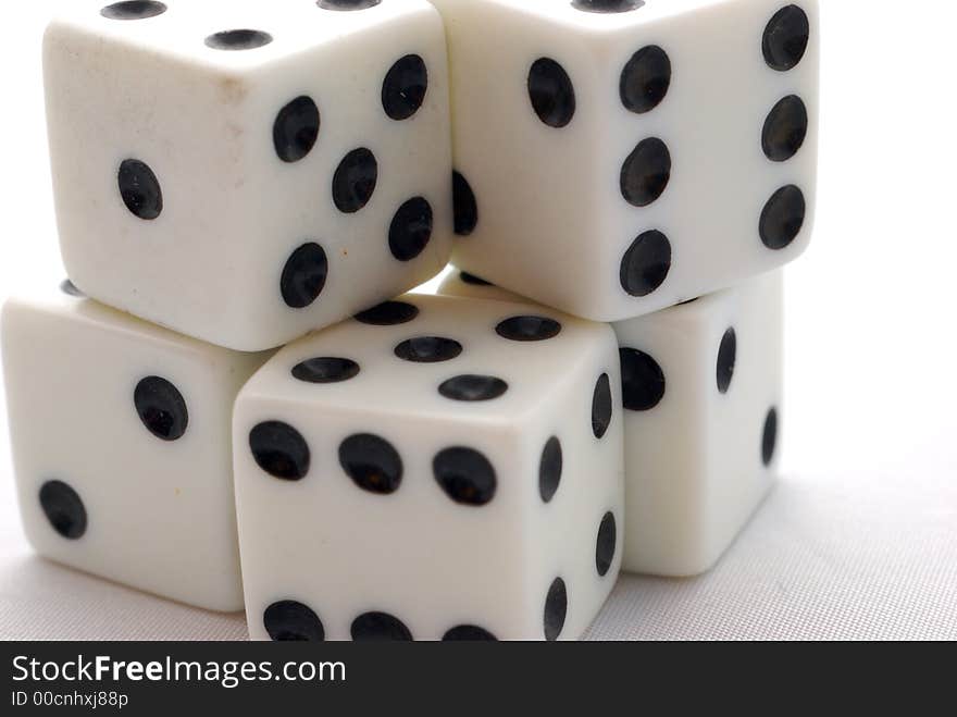 Five dices stacked up together in a whte background