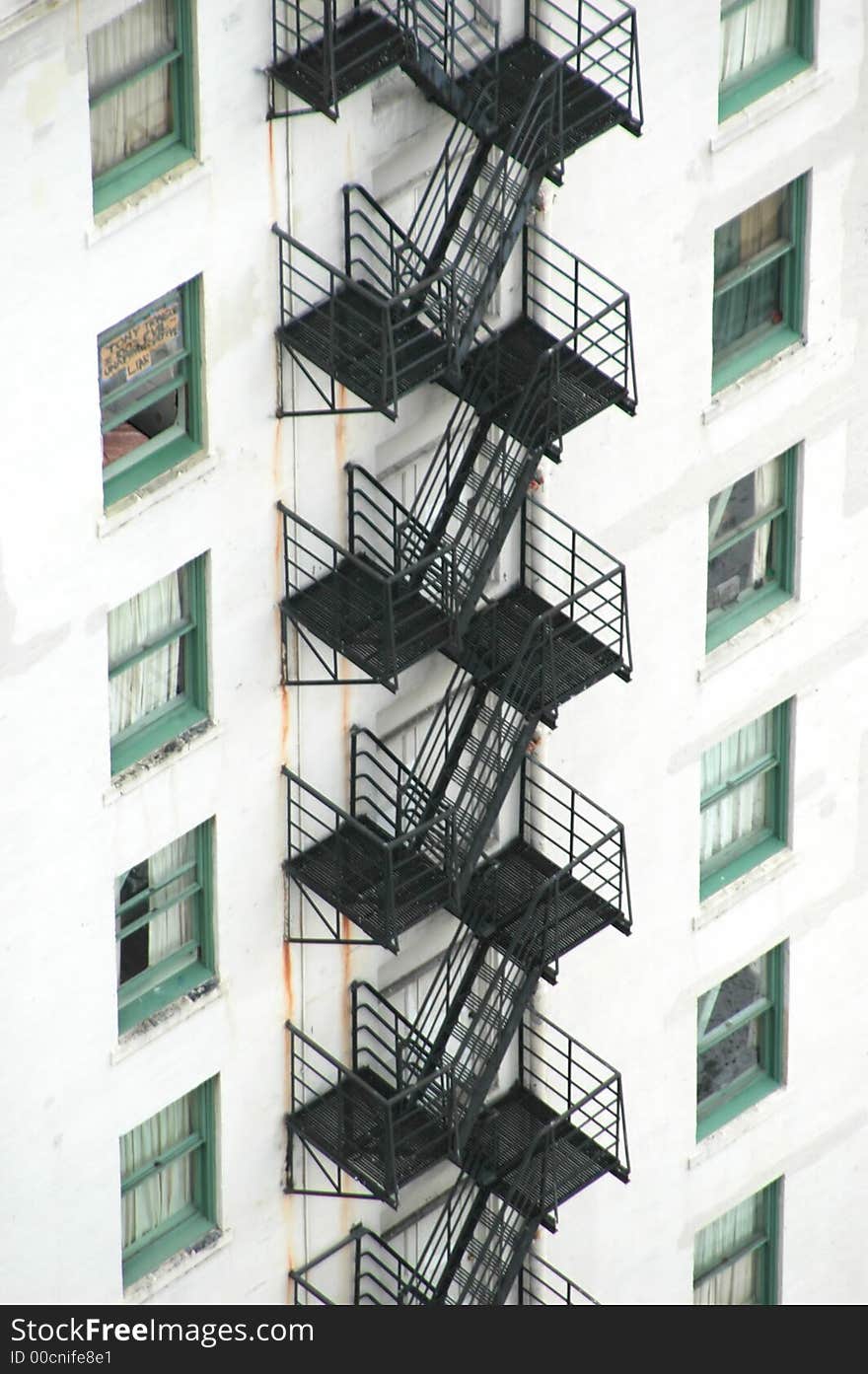 Apartment building with fire escape stairs attached.