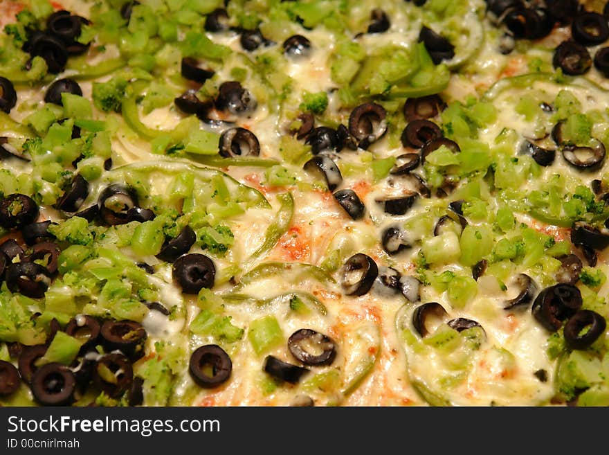 Vegetarian pizza with olives peppers and broccoli.