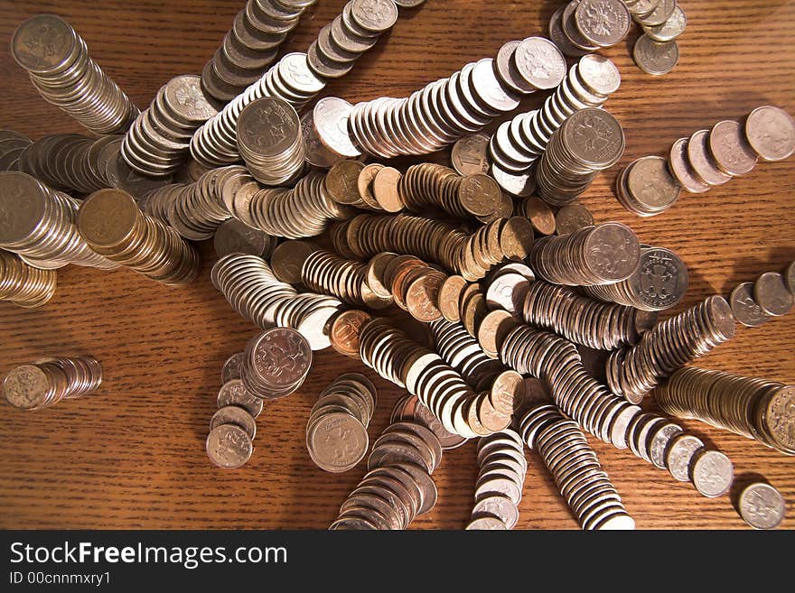 Set of coins in columns and  heaps on a table, (studio, halogen light). Set of coins in columns and  heaps on a table, (studio, halogen light).