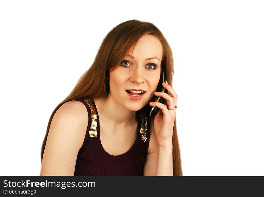 The girl emotionally talks by a mobile phone. The girl emotionally talks by a mobile phone.