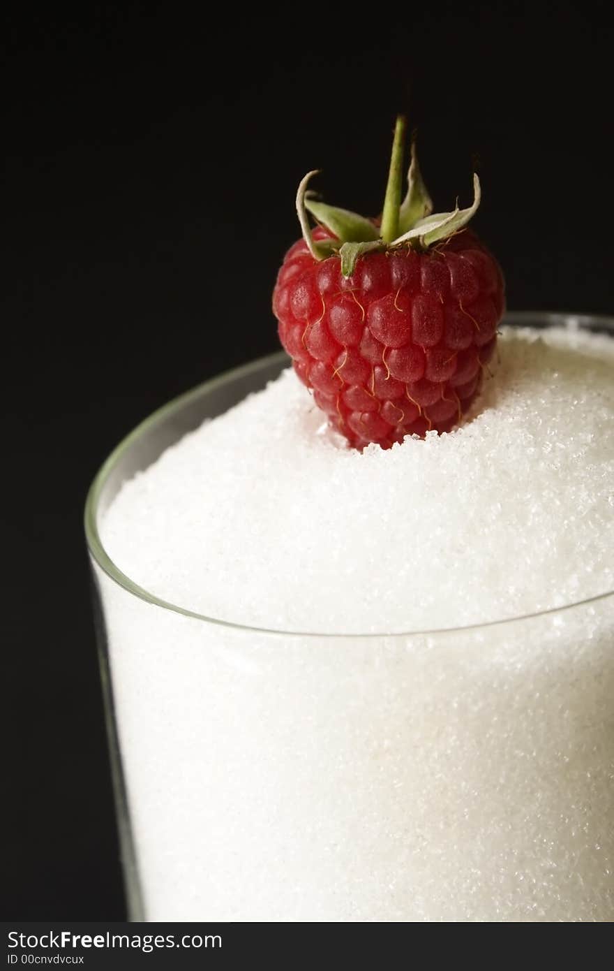 Sweet raspberry on glass full of sugar. Sweet raspberry on glass full of sugar