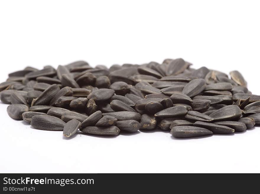 Black raw sunflower seeds on white