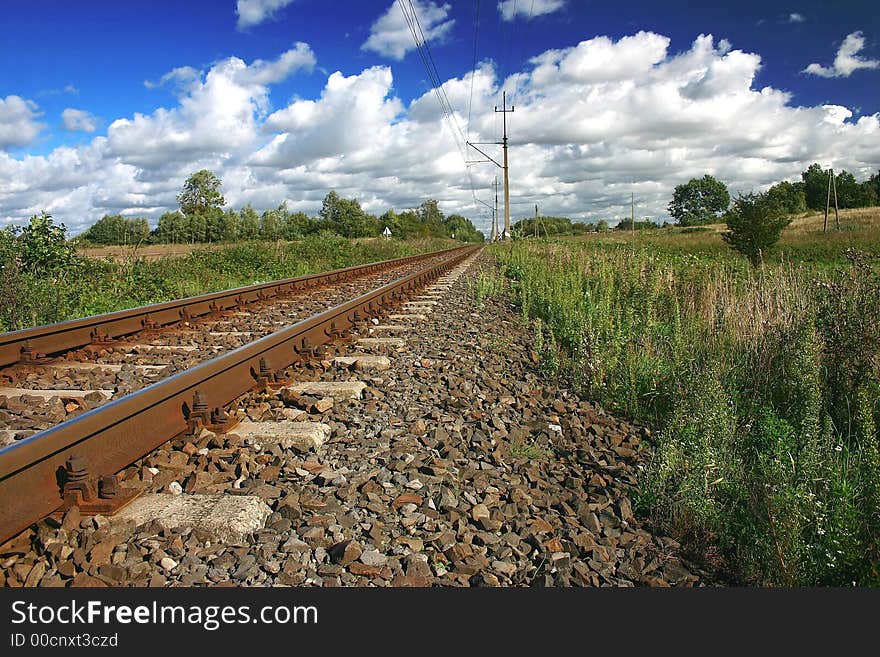 Railway on sunny day with beautiful clouds background.