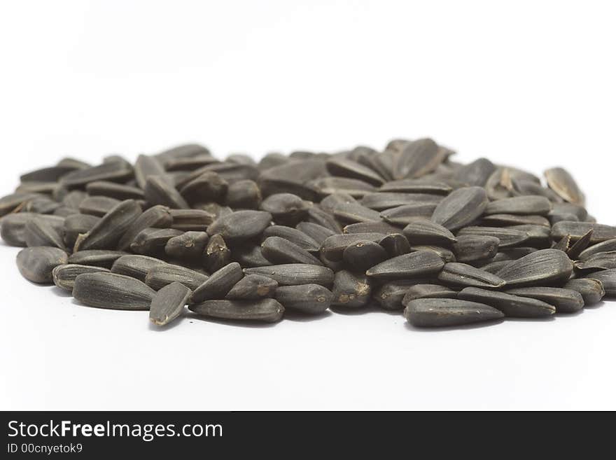 Black raw sunflower seeds isolated on white