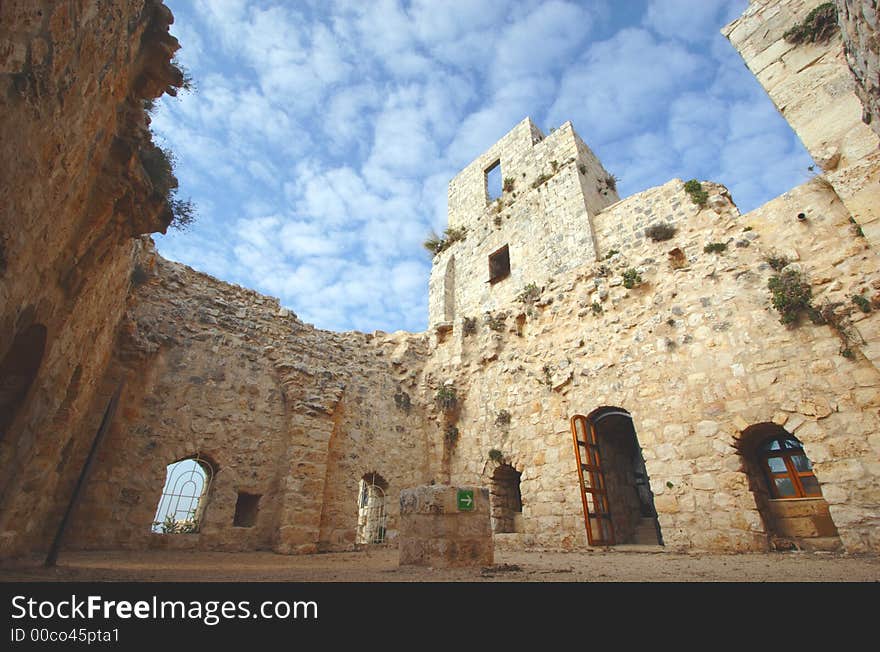 Wide angle view inside old castle with arrow points to the exit. Wide angle view inside old castle with arrow points to the exit