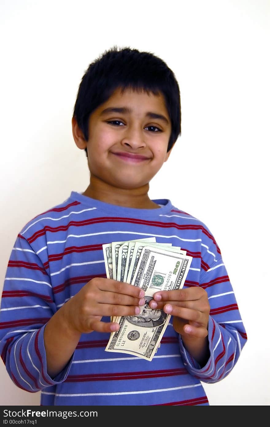 A kid very happy with money in his hands. A kid very happy with money in his hands