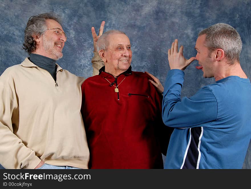 Grandfather, father, and son all in one photo, having fun. Grandfather, father, and son all in one photo, having fun