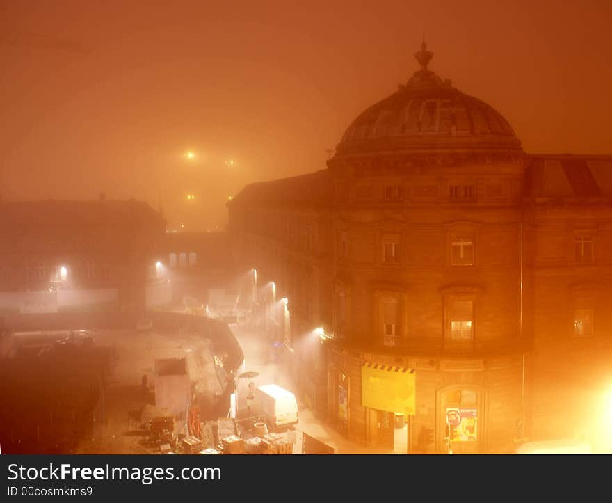 An old building on Strasbourg place de la gare in an orange morning mist. An old building on Strasbourg place de la gare in an orange morning mist