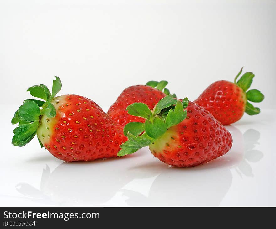 Strawberries on a gleamy surface